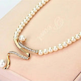 Set of a necklace and earrings with natural pearls